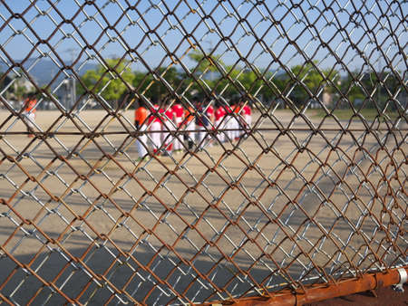 Ground beyond wire mesh fenceの写真素材