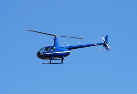 Small private helicopter flying by                   の写真素材