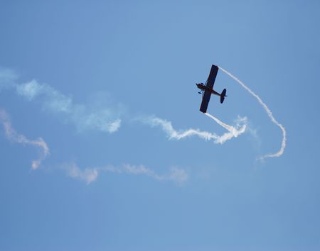 Small airplane performing aerobatic act                            