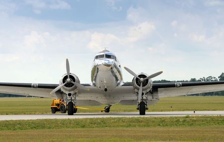 Classic turboprop airplane in silver color front view