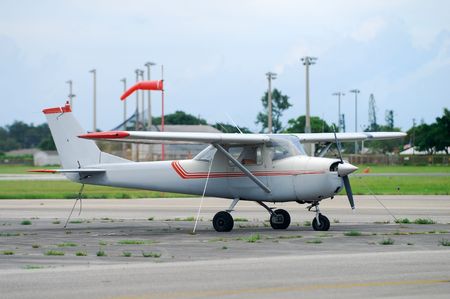 Light private airplane parked on the ground      