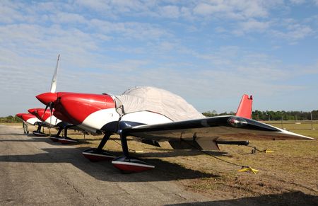 Three sports airplanes parked in a row