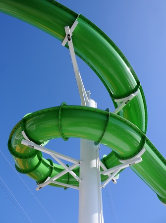 Green water slide at aquatic amusement park