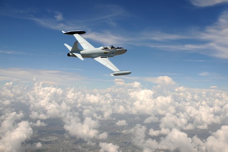 Old fighter jet soaring above the cloudsのeditorial素材
