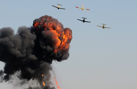 Old airplanes in a bombing run with smoke and fireのeditorial素材