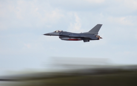 Military jet airplane at high speed with motion blurの写真素材