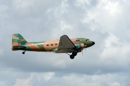 World War II era military cargi airplane in flightの写真素材