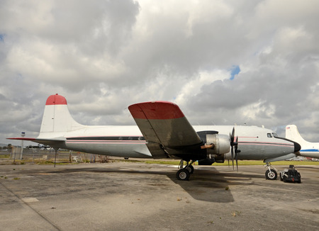 Retro propeller airplane on the ground side view