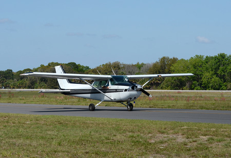 Light private airplane taxiing on the ground