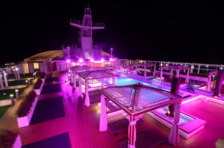 Ocean liner pool deck at night covered by purple lightのeditorial素材
