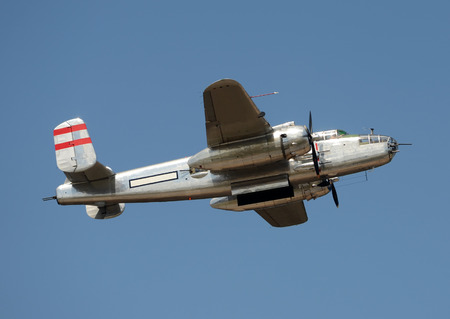 World War II era bomber in flight side view