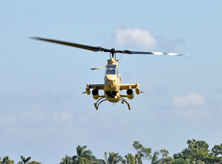 Military attack helicopter in flight front view