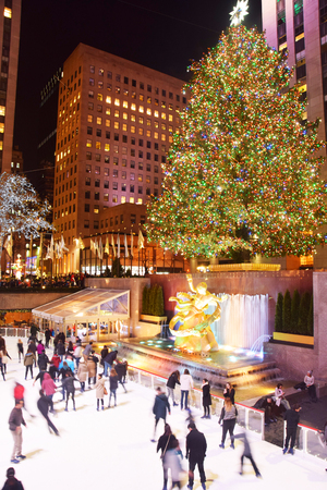 New York, USA - December 8, 2015: Locals and visitors skate under the Rockefeller Center chrostmas tree in New York City on December 8, 2015のeditorial素材