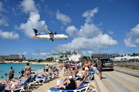 St Martin, Dutch Antelles - December 25, 2018: Airplanes land low over Maho Beach, St martin. the destination is a major tourist attraction of the island.のeditorial素材