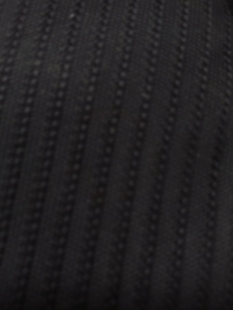 Close-up image of a black fabric texture. Abstract background.