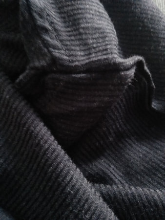 Black knitted fabric as a background, close-up, macroの写真素材