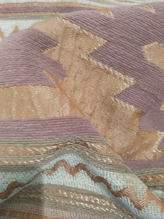 Background texture, pattern. The fabric is knitted in pastel colors with a checkered pattern....