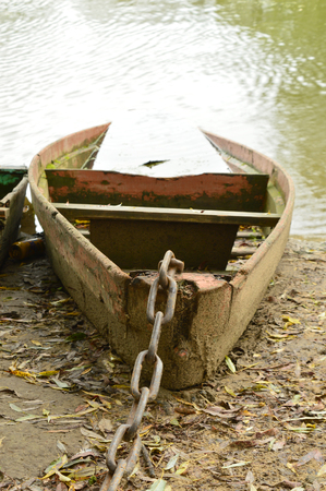 sunken wooden boat on the water tied chain. ukraineの写真素材