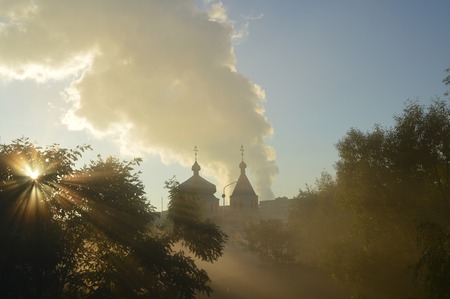 misty morning and sun's rays on the temple. Ukraineの写真素材