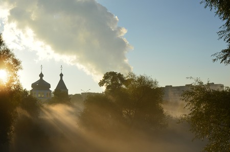 misty morning and sun's rays on the temple. Ukraineの写真素材