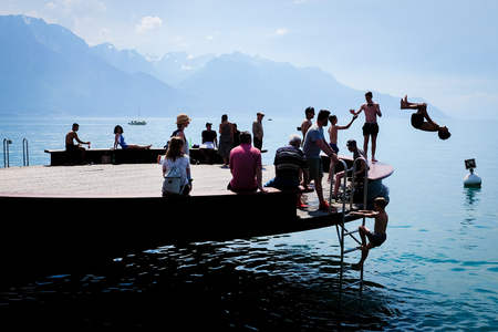MONTREUX, SWITZERLAND - MAY 28, 2017: People enjoy relaxing and jumping into Lake Geneva in the warm afternoon at Montreux, Switzerland.のeditorial素材