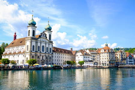 Cityscape of riverside buildings and church in Lucerne, Switzerland.の写真素材