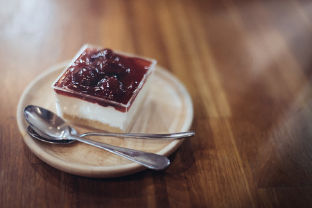 Strawberry cheese cake place on the wooden table  in soft focus and warm fall colorの写真素材