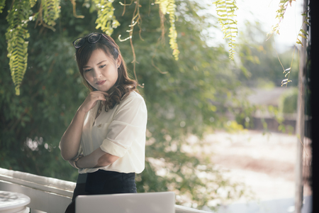Asian girl business thinking idea for a new project, freelance thinking idea for a new project in selective focus.の写真素材