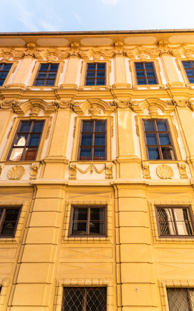 Graz, Styria / Austria - 20.01.2019: View at building with yellow facade with decorative windows...