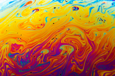 Rainbow soap bubble on a dark background. Close-up of colorful surface.の写真素材