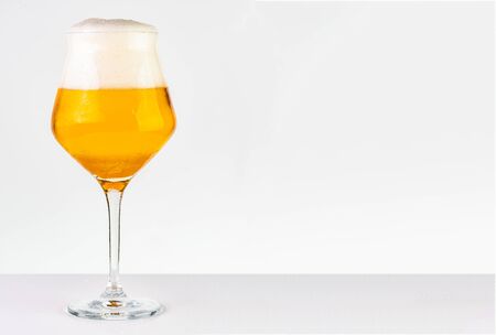 Glass of cold golden beer isolated on a white backgroundの写真素材