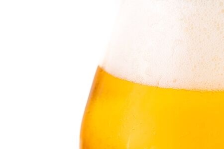 Glass of cold golden beer isolated on a white background