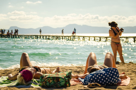 Alcudia, Spain 14.09.2011 - People sunbathing at sandy beach of Playa de Muro. Mallorca island famous tourist destination.のeditorial素材