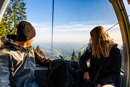 A couple in cable cart on the way to Schockl mountain. Famous travel destinationのeditorial素材
