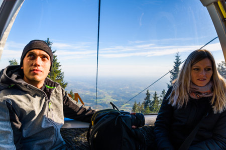 A couple in cable cart on the way to Schockl mountain. Famous travel destinationのeditorial素材