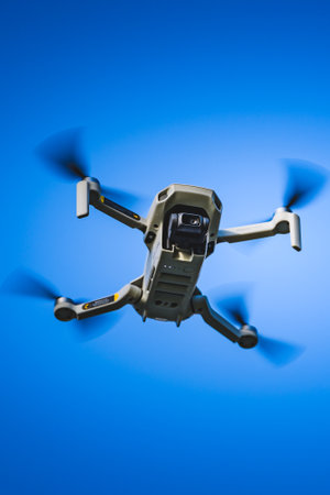 Graz, Austria - December 29 2019. DJI Mavic Mini drone flying in the countryside above frozen lake on sunny winter day. Drone flying.のeditorial素材