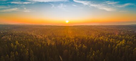 Aerial panorama view of countryside on sunny winter day in Styria , Austria. Route in beautiful nature landscape with sun, blue sky, and green forests. Backgroundの写真素材