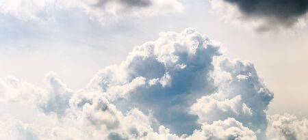 Clouds, close up view on a fluffy cumulus before storm. Background