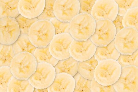 Background texture of sliced banana pieces. Abstract pattern of fruit.の写真素材