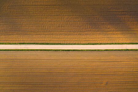 Plowed field in rural area. Landscape of agricultural fields. Aerial view