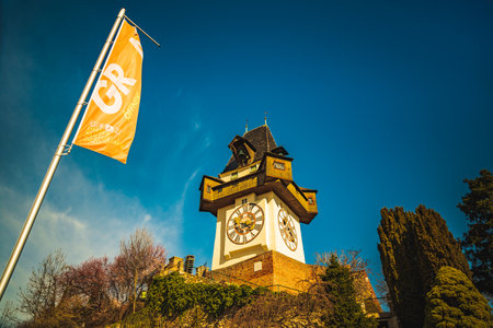 Graz, Austria - 10.03.2020: Uhrturm landmark in Graz cityscape view, Styria region of Austria. Clocktower against blue skyのeditorial素材