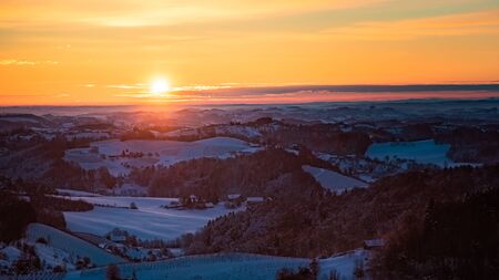 Landscape of sunrise over the the Austrian vineyards and the foggy in valleys of Slovenia Austria border. Place to visit in Europeの写真素材