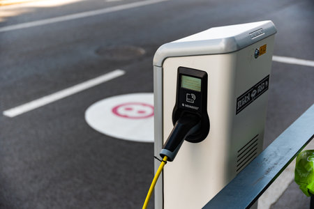 Charging station for electric cars in city. New energy vehicles, eco-friendly alternative energy for carsのeditorial素材