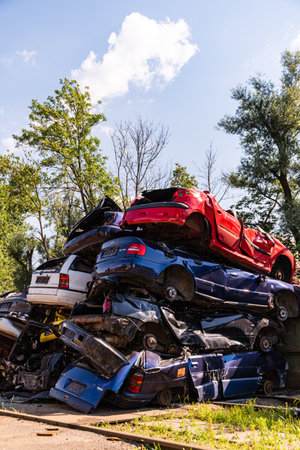 Graz, Austria - 24.06.2020 - Cars piled on top of each other in junkyardのeditorial素材