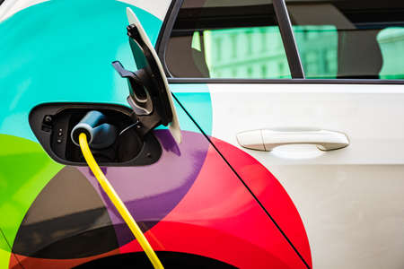 Charging battery of an electric car in city.の写真素材