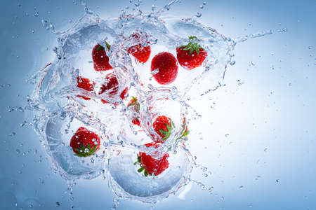 Raspberries splashing into clear water, view from top. Health food conceptの写真素材