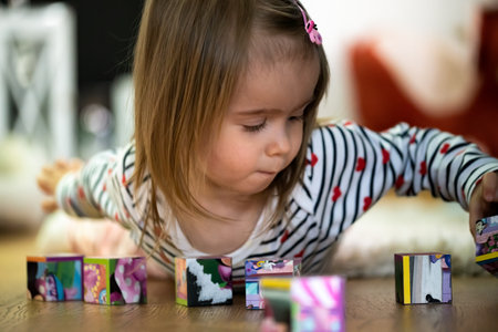 Child focused on playing with toy blocks