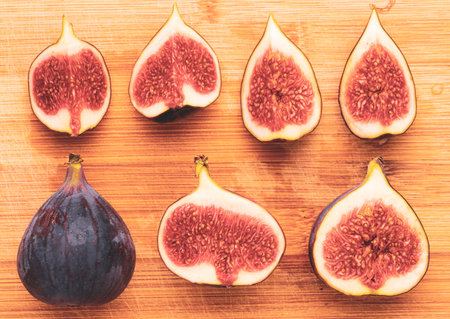 Fresh figs isolated on wooden background.