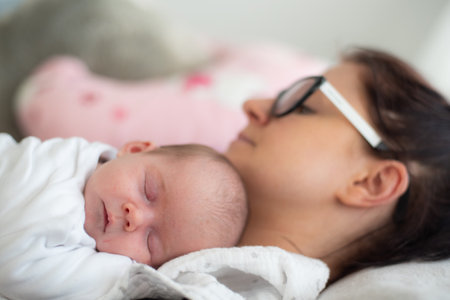 A mother is lying with the newborn baby.の写真素材