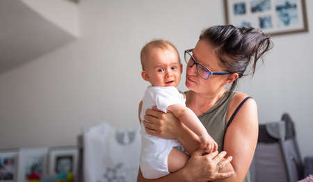 happy mother holding her babyの写真素材